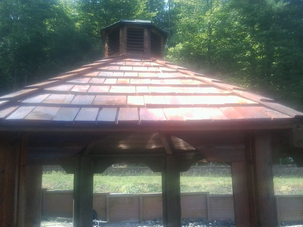 New cedar shake roof and cupola on a lakeside gazebo in Middletown